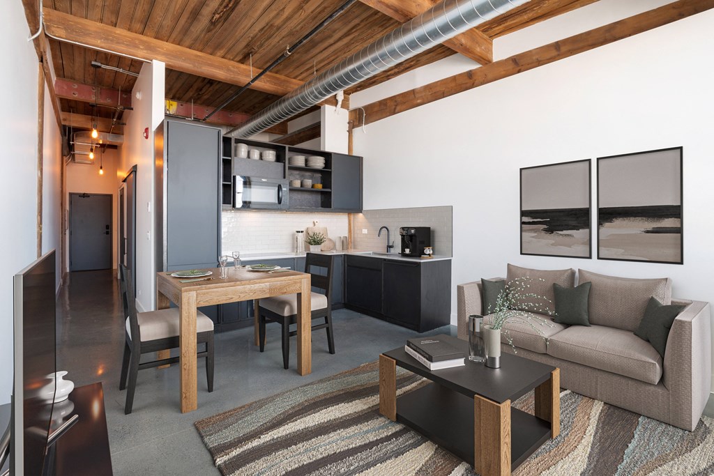 a view of a living room and kitchen in a loft apartment