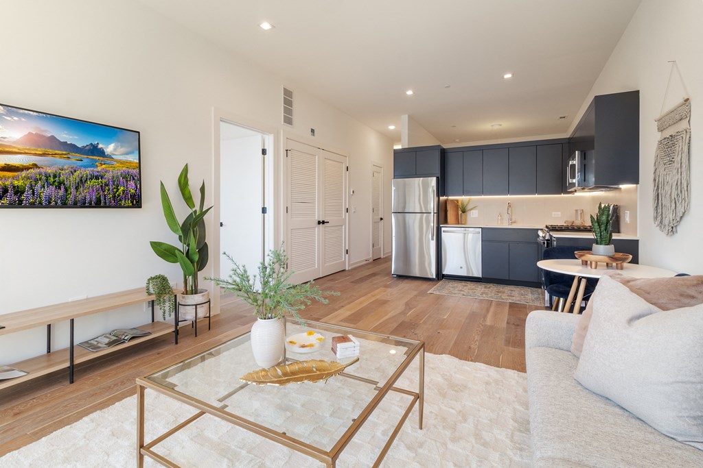 a living room with a couch and a glass coffee table