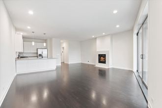 a living room with white walls and a fireplace