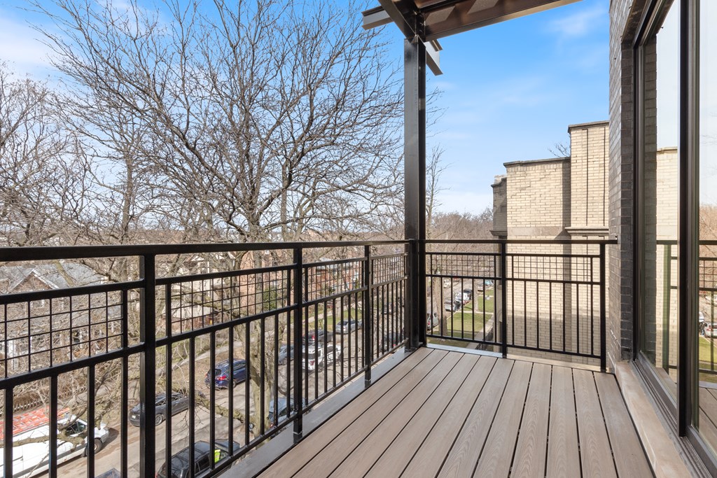 the deck has a view of the parking lot and the building in the background