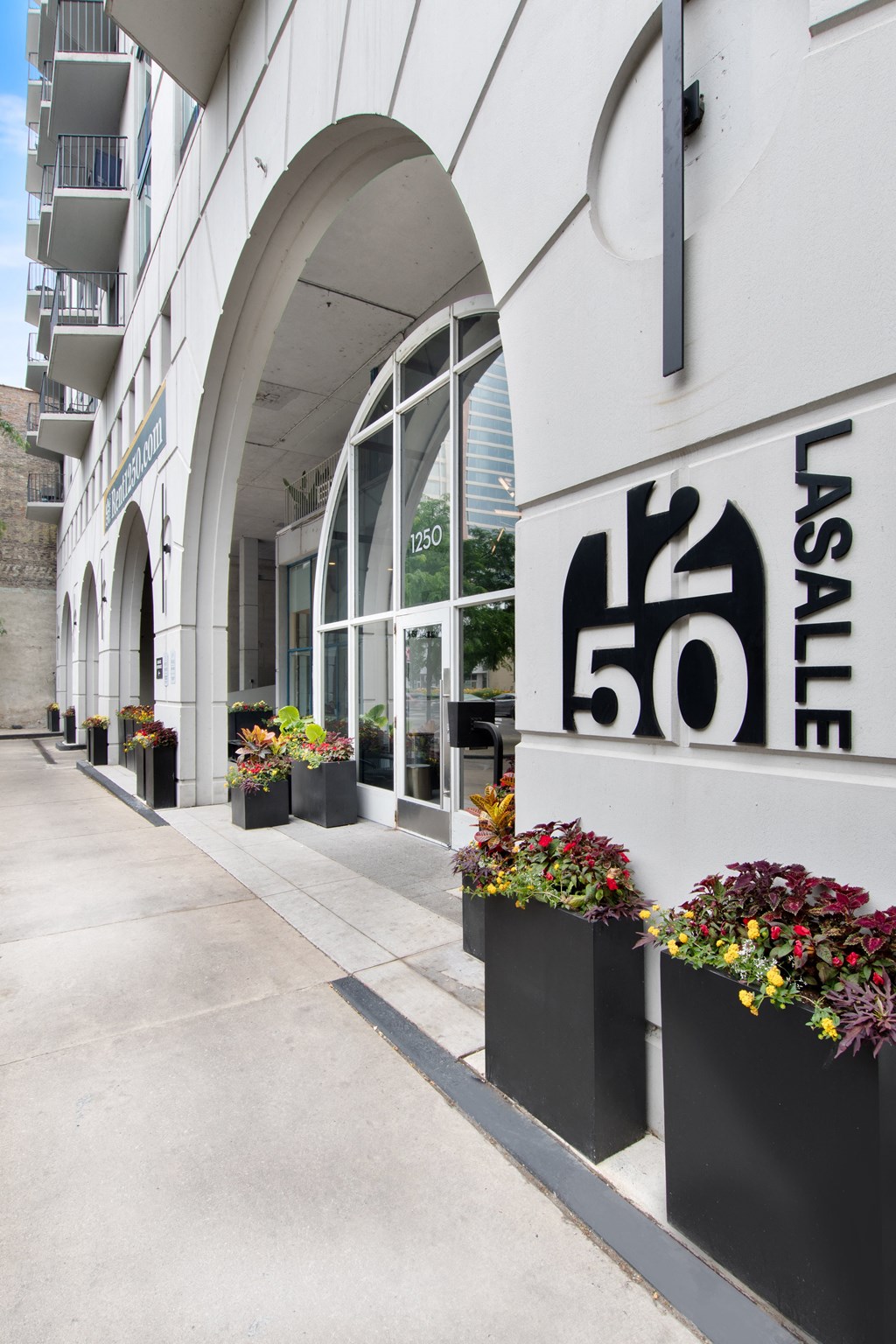 An external shot of the 1250 LaSalle building with modern logo on the wall