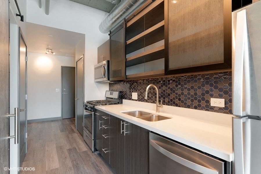a kitchen with a sink and a refrigerator