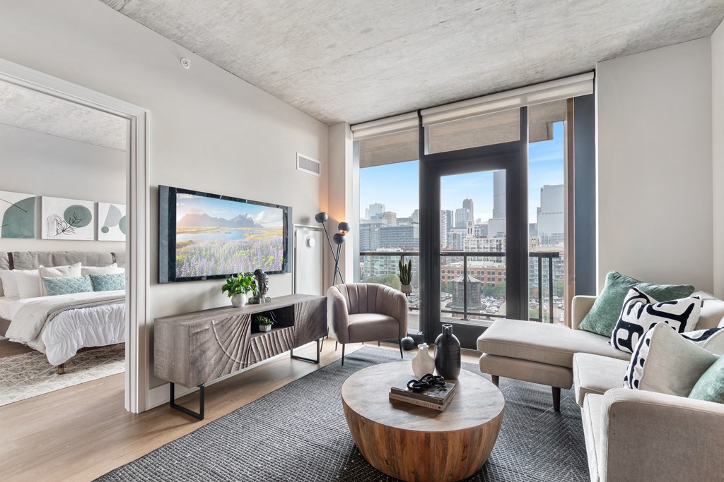 a living room with a couch and a chair and a tv