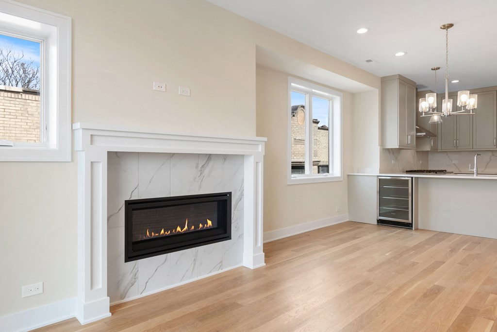 a living room with a fireplace and a kitchen
