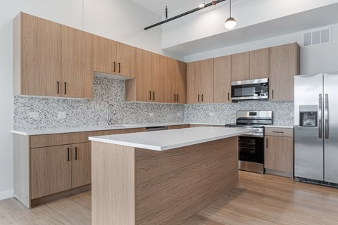 A kitchen with wooden cabinets and a white countertop.