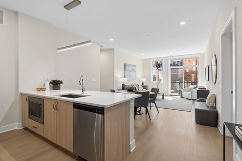 A modern kitchen with wooden cabinets and a large island.
