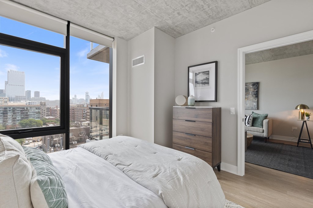 a bedroom with a bed and a view of the city