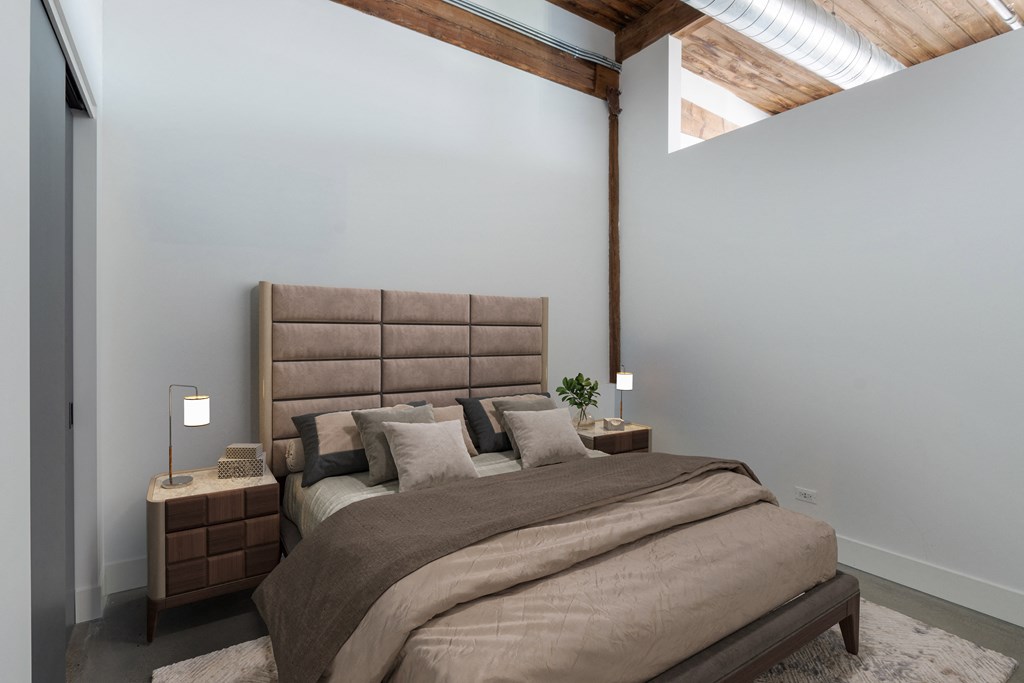 a bedroom with a bed and two nightstands