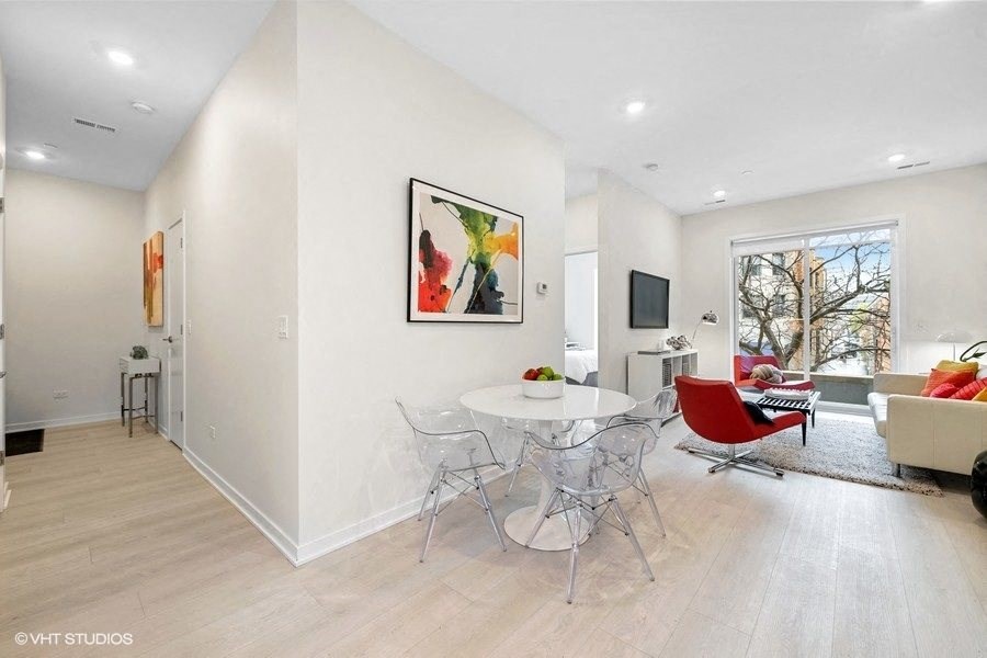 a dining room with a table and chairs and a living room