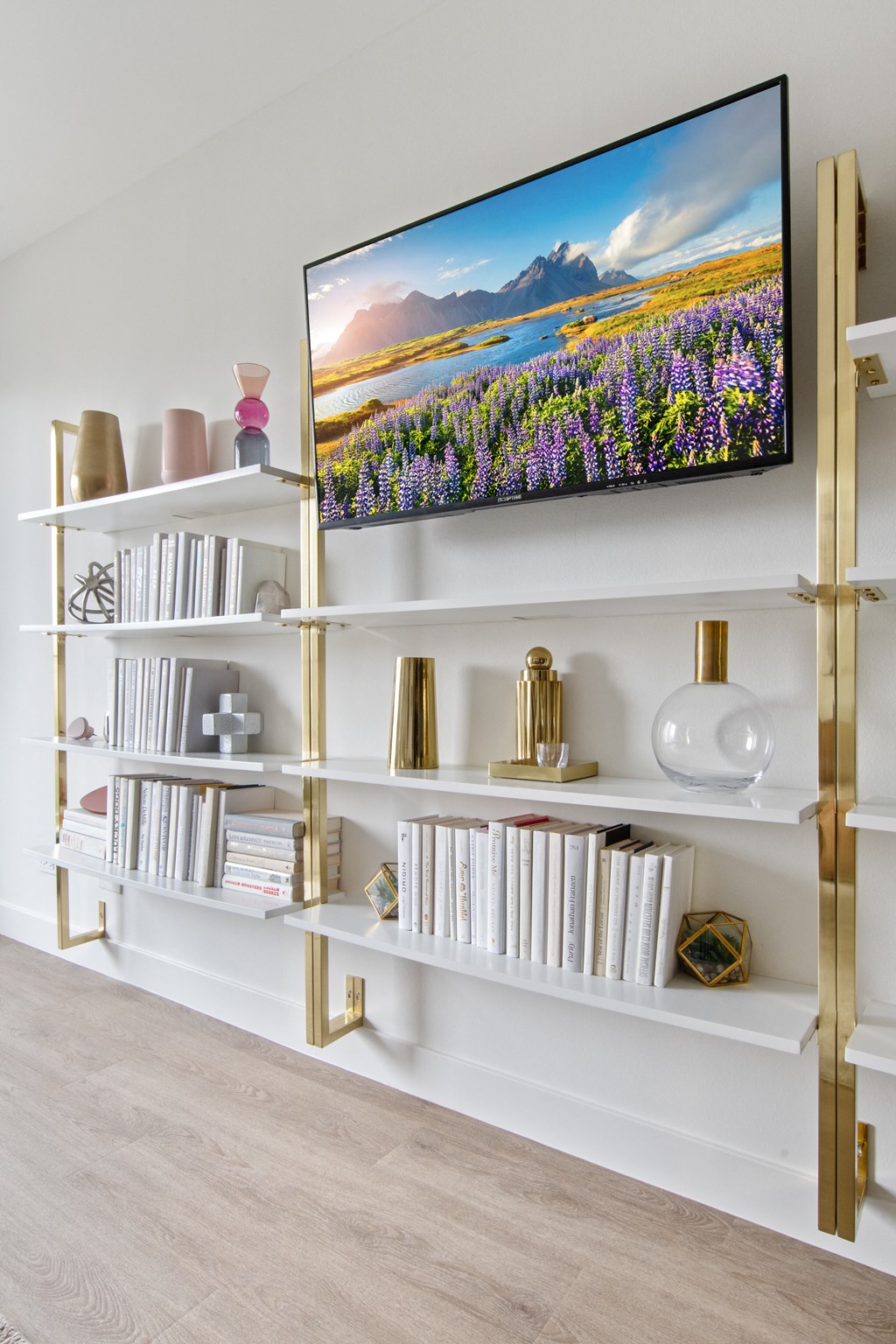 A flat screen TV mounted on a wall above a bookshelf in the living room at 1250 LaSalle