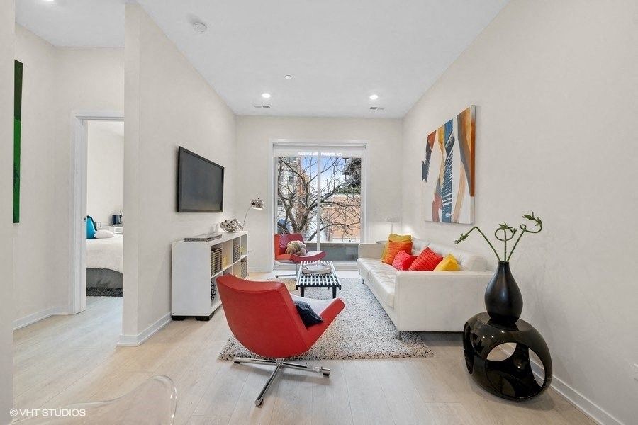 a living room with a couch and a chair and a television