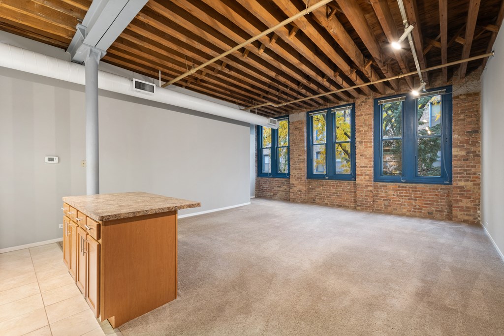 an empty room with a bar in the middle of it