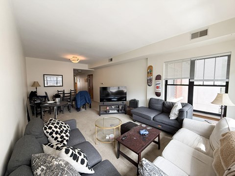 A living room with a grey couch and a coffee table.