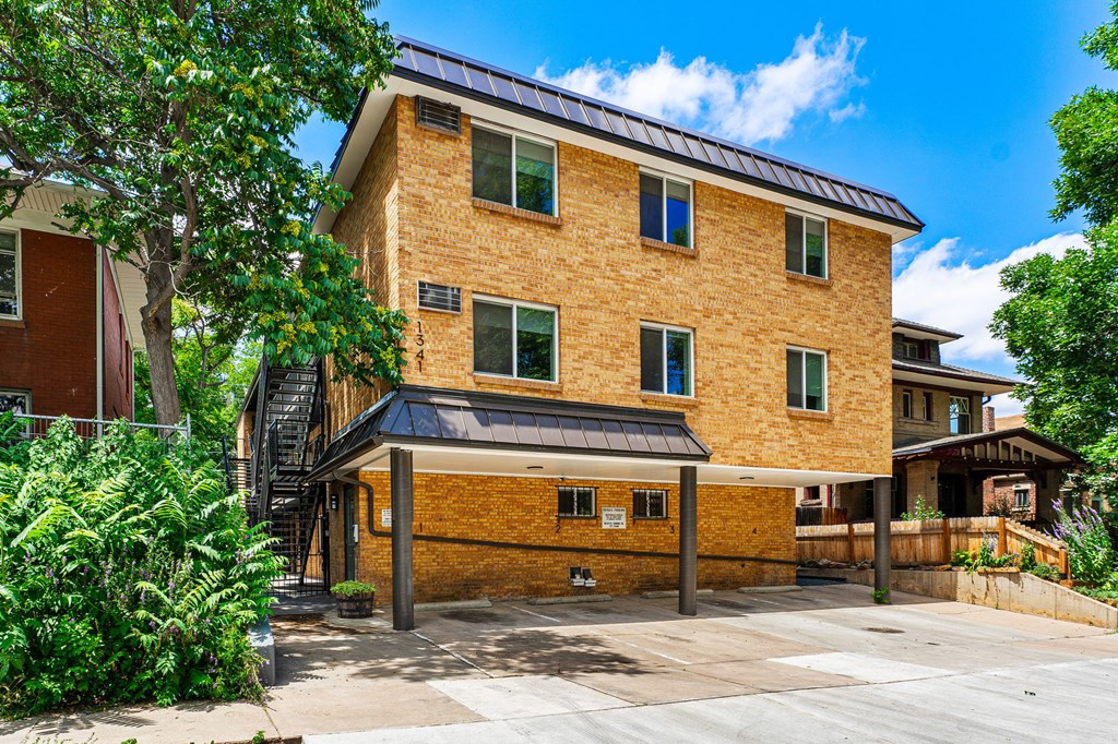 a brick building with a black awning on the side of it