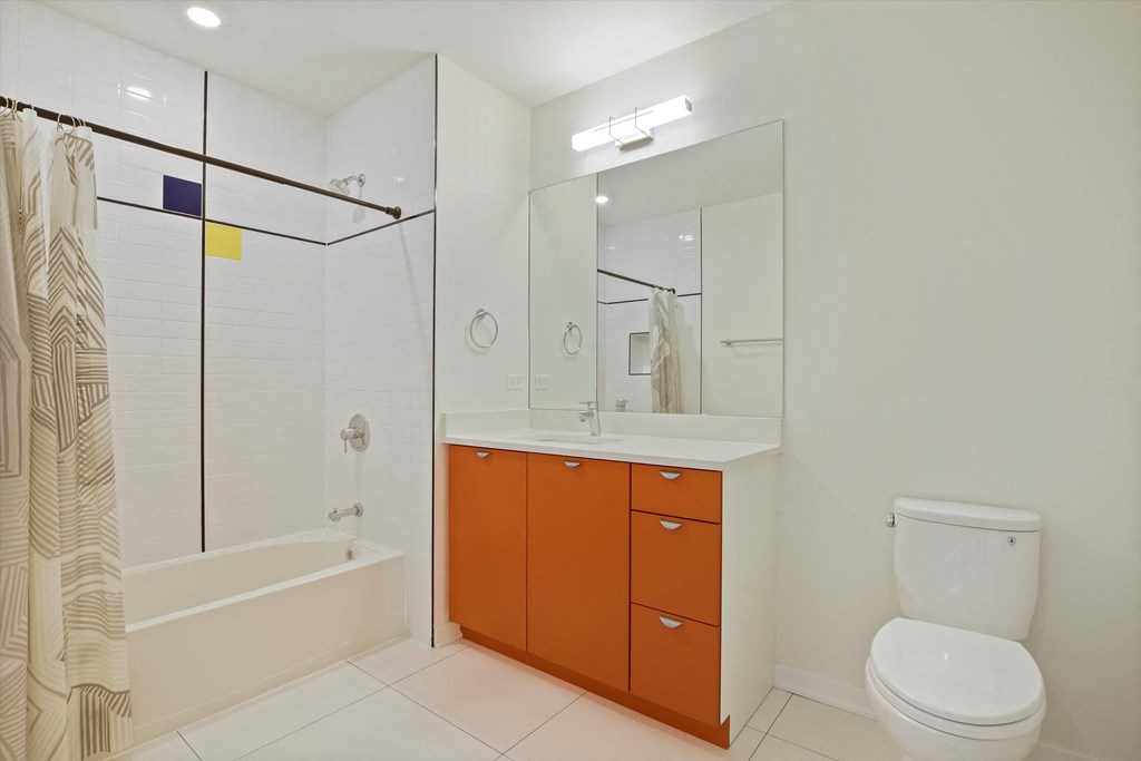 a bathroom with a shower toilet and a sink