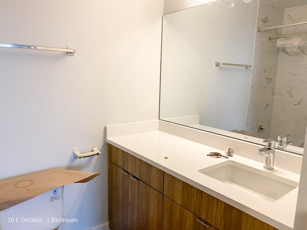 an empty bathroom with a sink and a mirror
