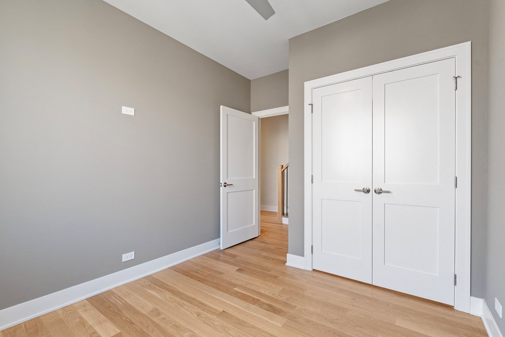 an empty room with two closets and a wood floor