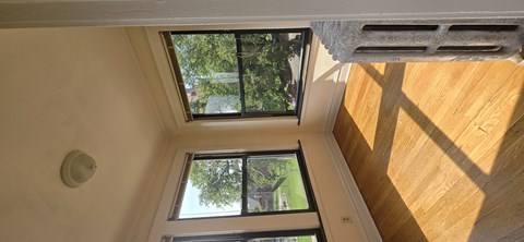 A view from the top of a stairwell looking down at a window.