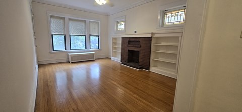 A room with a fireplace and a window.