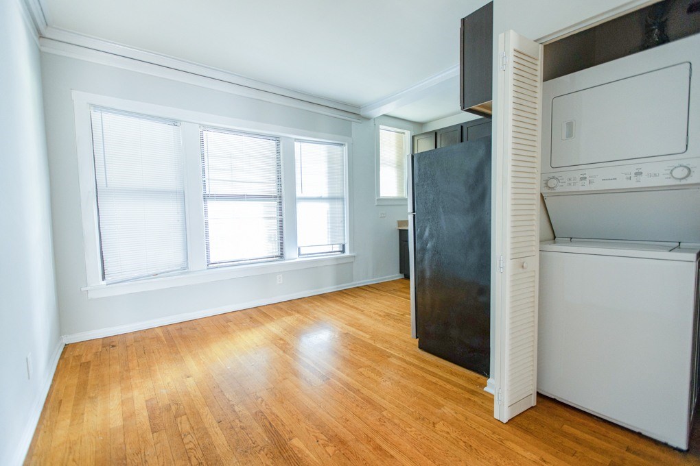 A kitchen with a black refrigerator and white oven.
