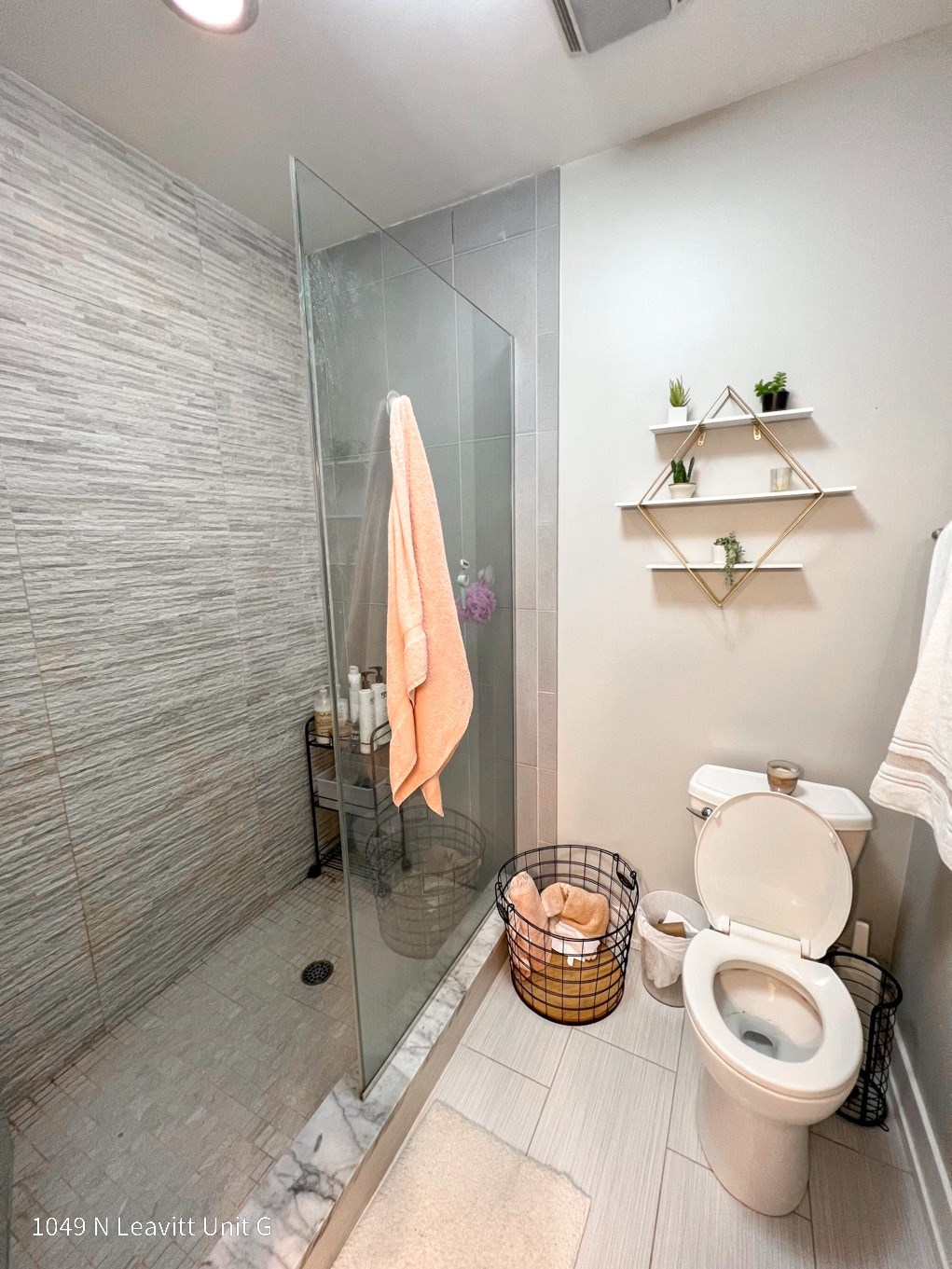 a small bathroom with a walk in shower and a toilet