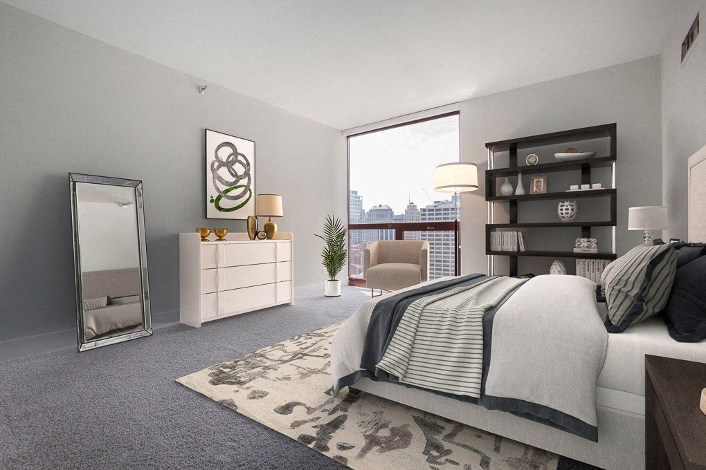 a bedroom with a bed and a large window