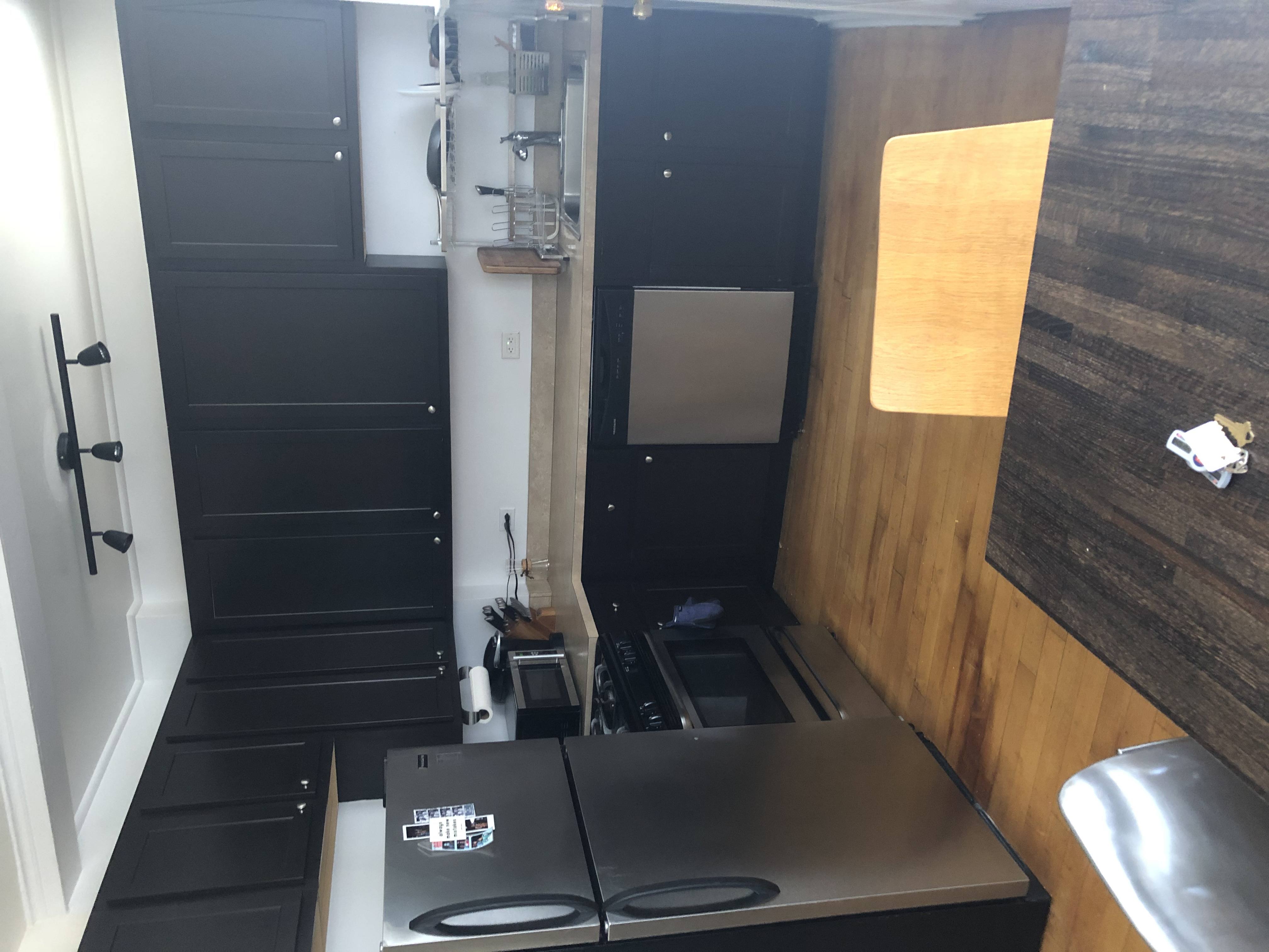 A small kitchen with a stove top oven and a sink.