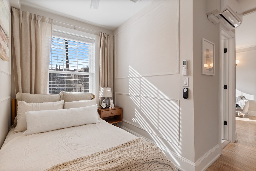 a bedroom with a bed and a window