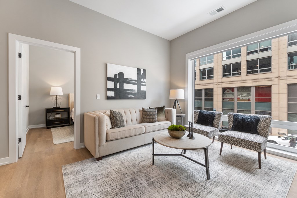 a living room with a couch and two chairs and a table