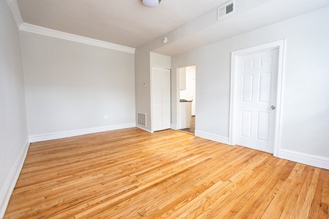 A room with wooden floors and white walls.