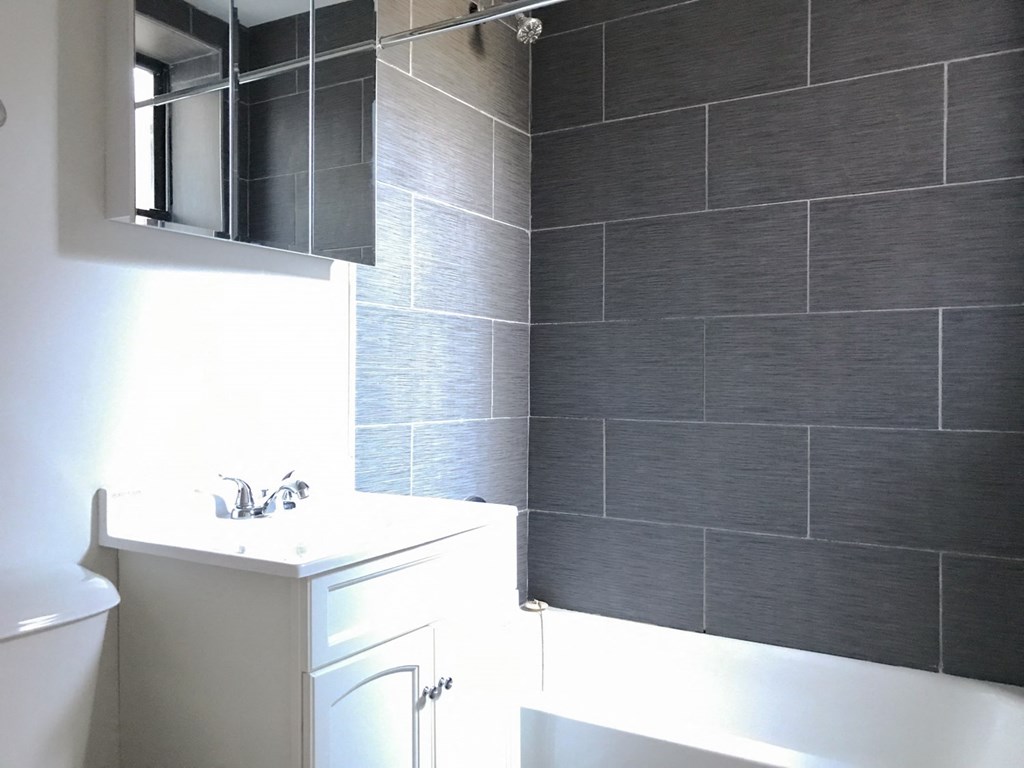 a bathroom with a sink and a mirror and a toilet