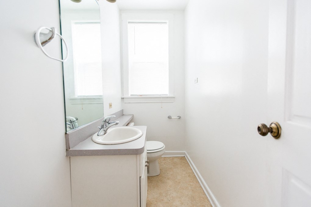 a bathroom with a sink and a toilet and a mirror