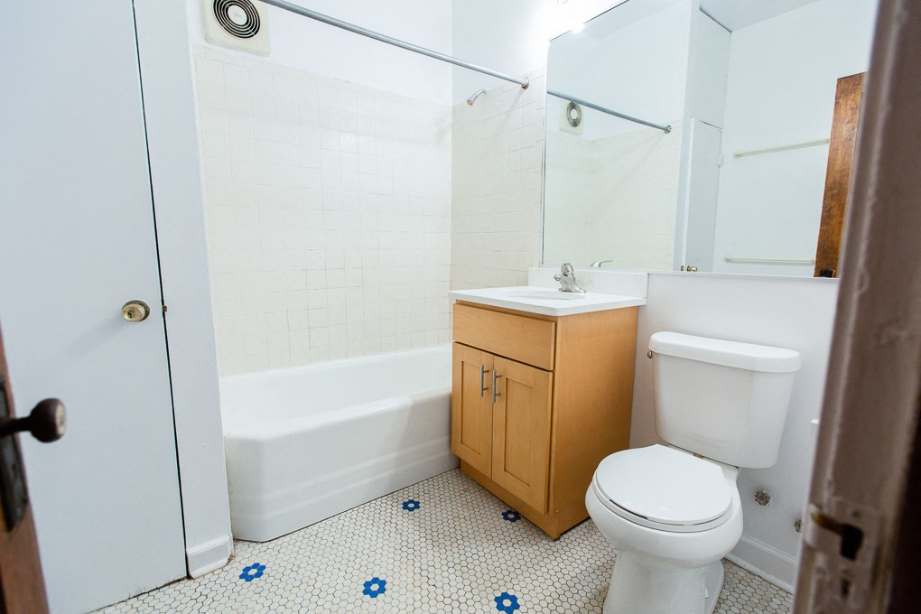 an empty bathroom with a toilet and a sink