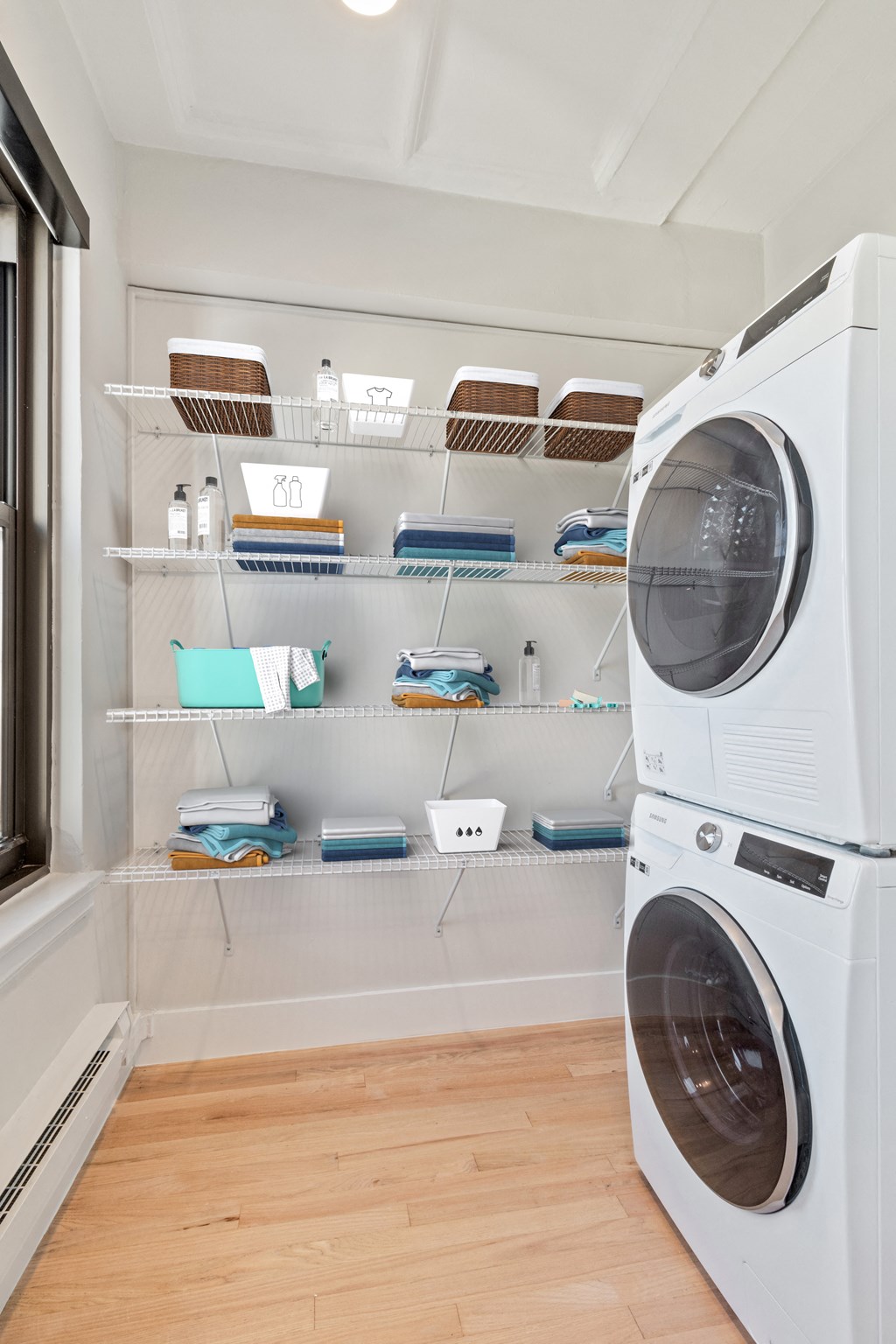a laundry room with shelves and a washer and dryer