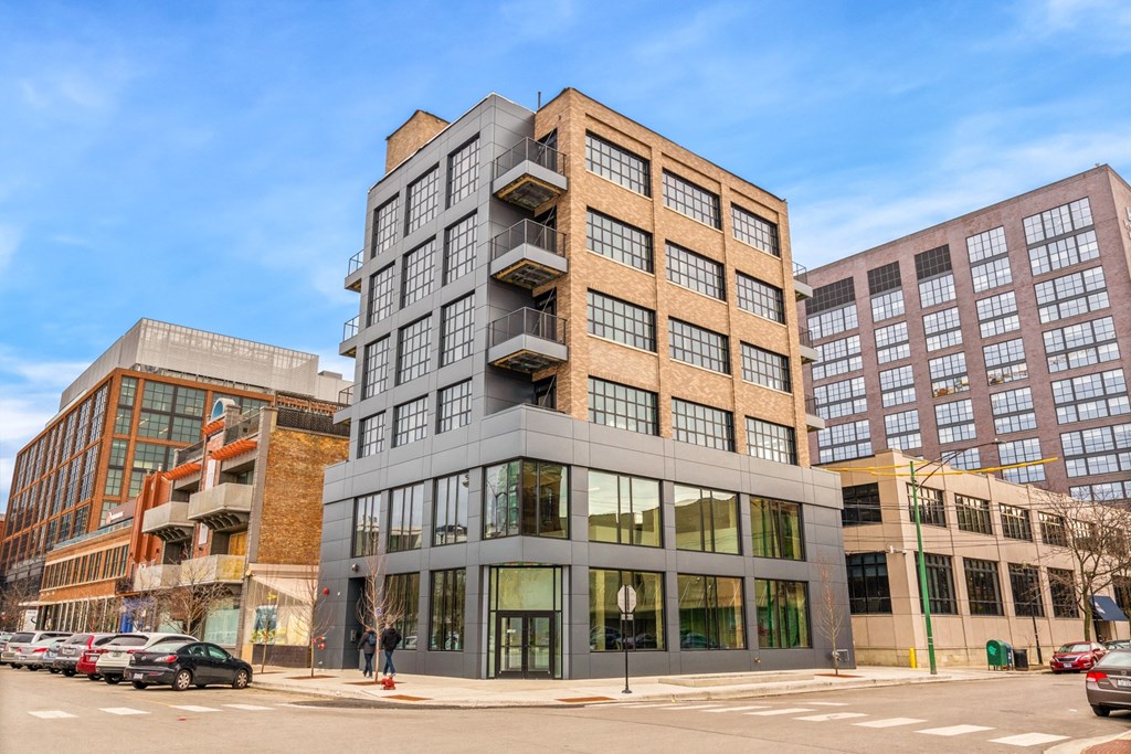 a tall building on a city street with other buildings