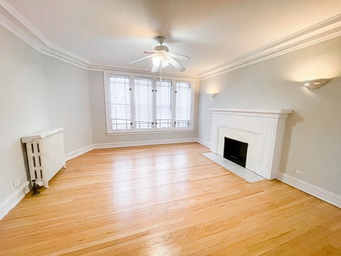 A room with a fireplace and a ceiling fan.