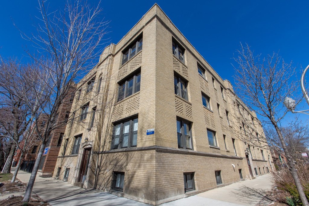 an old brick building with a blue sky in the background