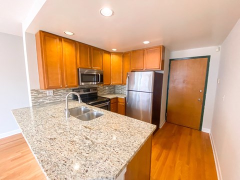 full kitchen with granite counter tops and stainless steel appliances