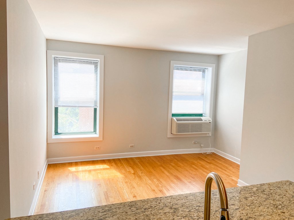 an empty room with an air conditioning unit and a window