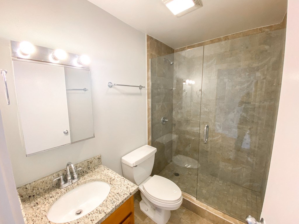 a bathroom with a sink toilet and shower