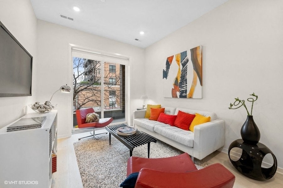 a living room with a white couch and a television