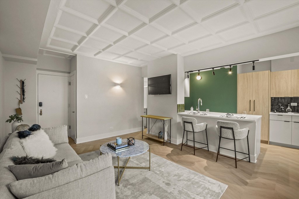 a living room with a couch and a table with two chairs