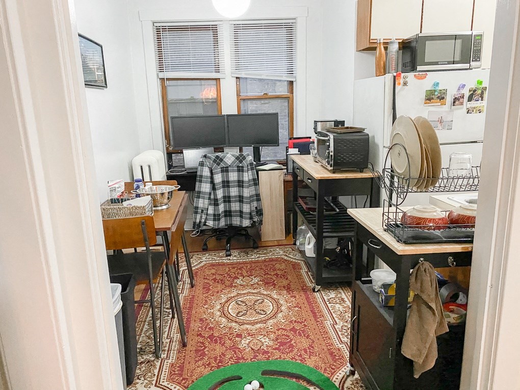 a small room with a kitchen and a tv
