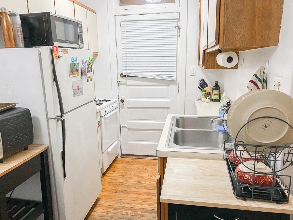 a small kitchen with a refrigerator and a sink