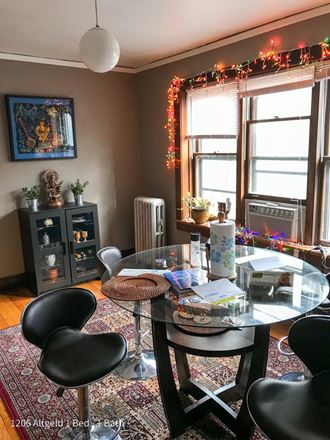 a dining room with a glass table and black chairs