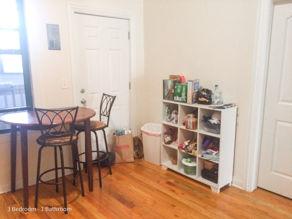 a dining room with a table and chairs and a bookshelf