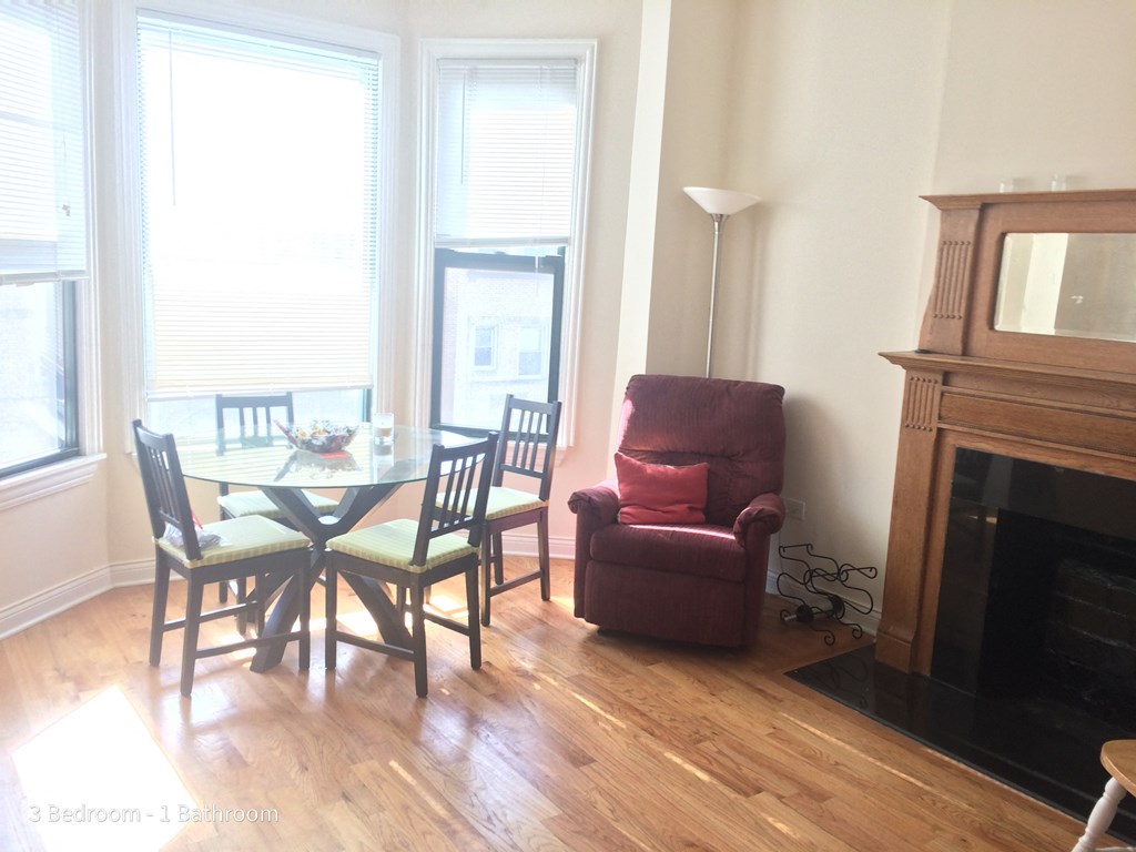 a dining room with a table and chairs and a fireplace