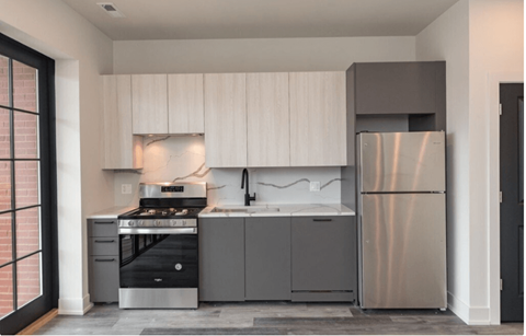 a small kitchen with stainless steel appliances and white cabinets