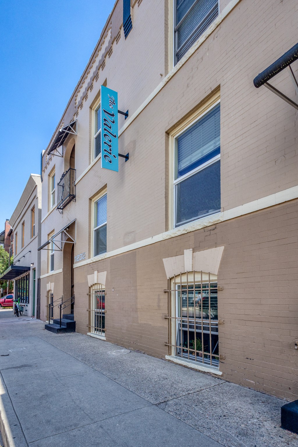 a building with a blue sign on the side of it on a street