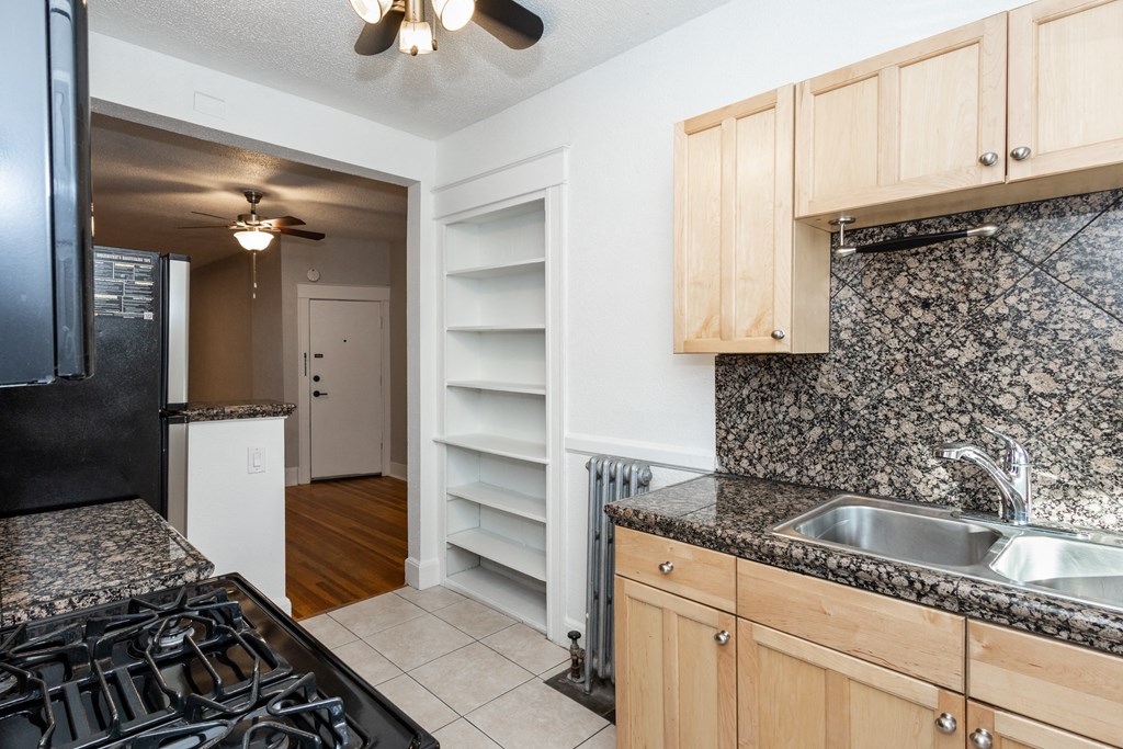 a kitchen with granite counter tops and a stove and a sink